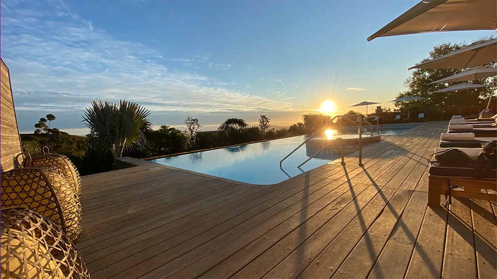 deck with pool and sunset
