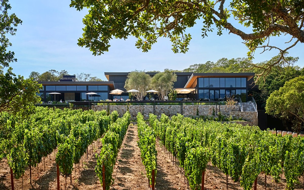 Exterior of Montage Healdsburg from across a vineyard