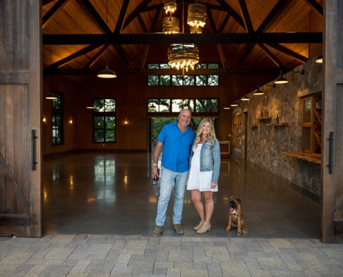 Man and woman with a dog in the entrance to a tasting room - lot for SCWA