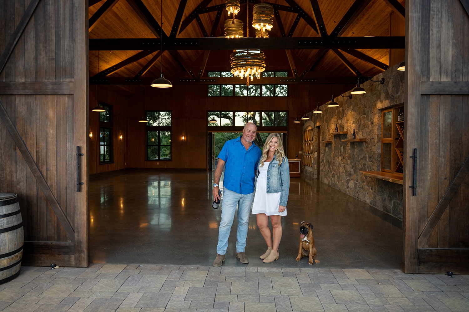 Man and woman with a dog in the entrance to a tasting room