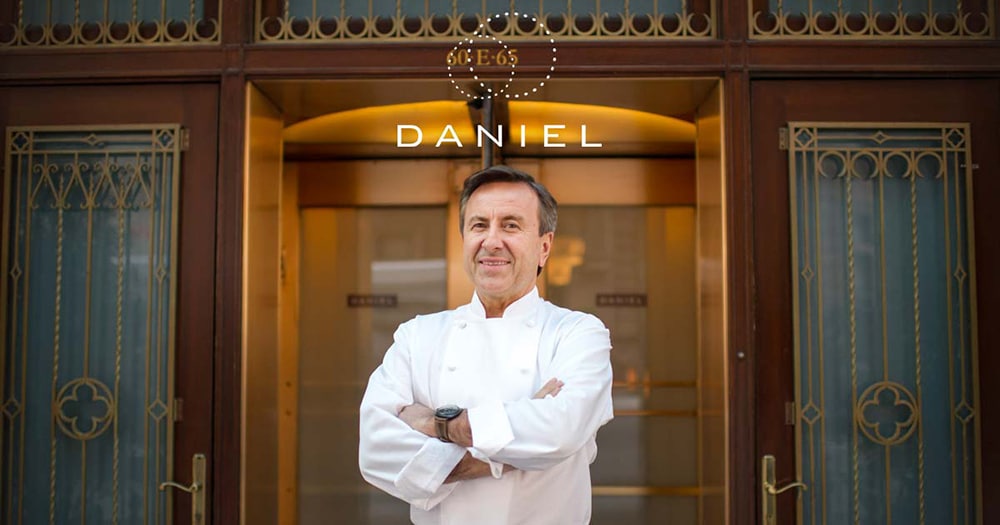 Chef Daniel Boulud standing in front of Daniel restaurant