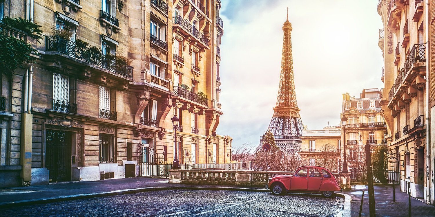 Paris street view with a red car and the Eiffel Tower
