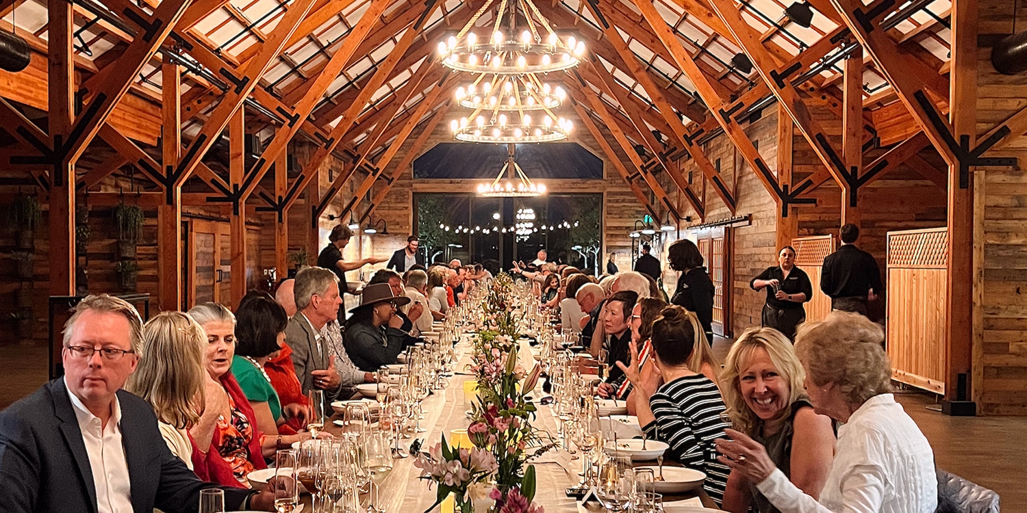 Long dinner table with guests inside Bricoleur Vineyards