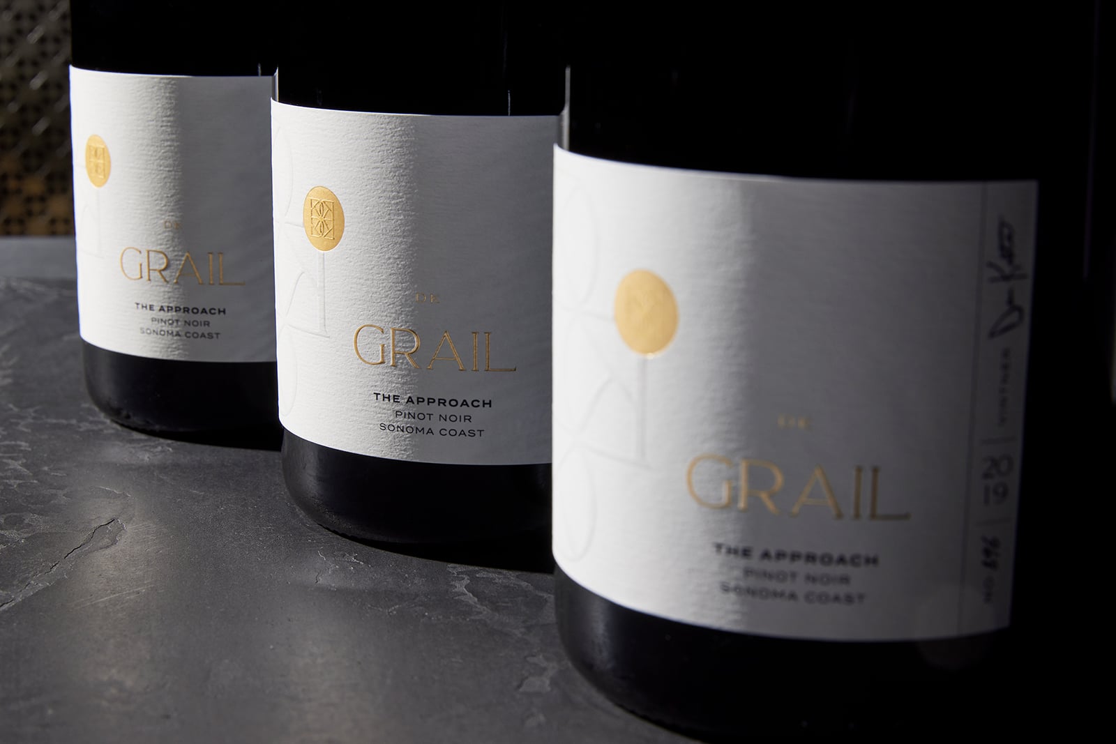 Three bottles of The Grail Pinot Noir